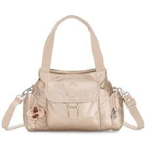 Beautiful new with tags Kipling purse in toasty gold color.